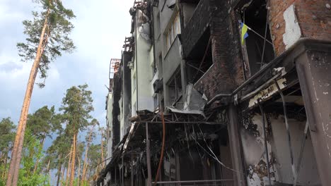 The-Ukrainian-Flag-In-Burned-Window-Sill-Of-Destroyed-Apartment-Complex-In-Irpin-Kyiv-Ukraine