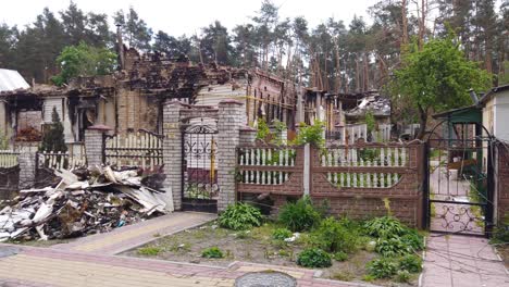 Moving-Shot-Approaching-Burned-Out-House-In-A-Neighborhood-Of-Irpin-Ukraine-Following-Russian-Missile-Attacks
