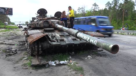 Chldren-Play-On-An-Abandoned-Russian-Tank-Along-A-Highway-Into-Kyiv-Following-The-Russian-Invasion