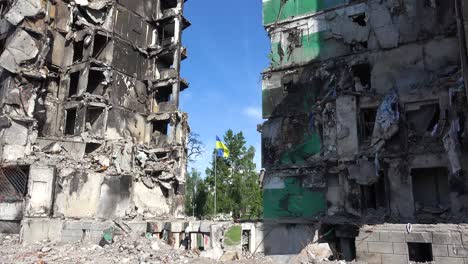 The-Ukrainian-Flag-Flies-Proudly-In-Front-Of-Borodyanka,-Ukraine-Bombed-And-Rocketed-Apartment-Buildings-Where-Hundreds-Were-Killed-By-Russian-Occupation