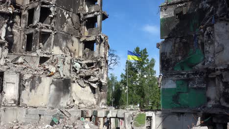 The-Ukrainian-Flag-Flies-Proudly-In-Front-Of-Borodyanka,-Ukraine-Bombed-And-Rocketed-Apartment-Buildings-Where-Hundreds-Were-Killed-By-Russian-Occupation