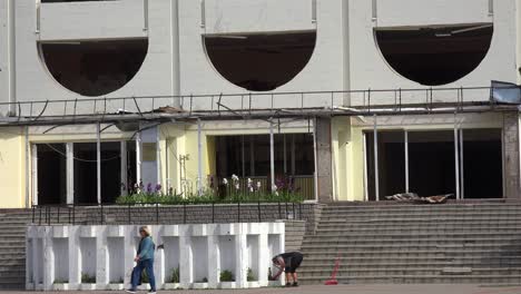 Establishing-Shot-Of-The-Badly-Damaged-Borodyanka-Palace-Of-Culture-With-Volunteers-Cleaning-Up-The-Damage-Outside