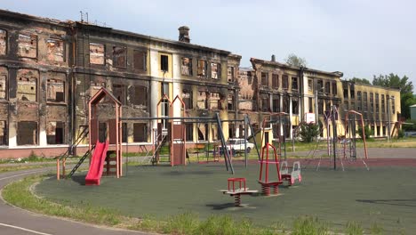 A-Badly-Damaged-School-Building-With-Children'S-Playground-Foreground-In-Saltivka,-Kharkiv,-Ukraine