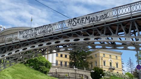 A-Bridge-Over-A-Roadway-In-Kyiv,-Kiev,-Ukraine-Carries-A-Message-To-Save-Mariupol