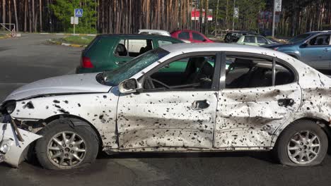 A-Car-Riddled-With-Bullet-Holes-Stands-In-Bucha-Ukraine-Following-The-Russian-Occupation-And-Invasion-Of-That-Country