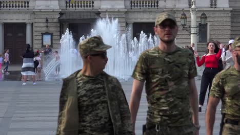 Ukrainian-Army-Soldiers-In-Uniform-Walk-Through-Central-Lviv,-Ukraine