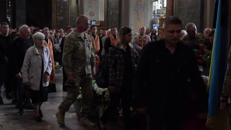 Mourners-Pass-By-And-Lay-Offerings-At-The-Coffin-Of-A-Dead-Ukrainian-Soldier-During-A-Funeral-Service-In-Lviv,-Ukraine