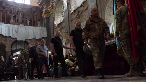 Mourners-Pass-By-And-Lay-Offerings-At-The-Coffin-Of-A-Dead-Ukrainian-Soldier-During-A-Funeral-Service-In-Lviv,-Ukraine