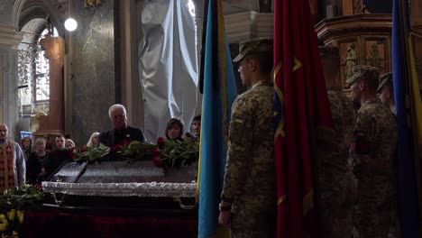 A-Catholic-Priest-Administers-Last-Rites-Over-The-Coffin-Of-A-Dead-Ukrainian-Soldier-During-A-Funeral-Service-In-Lviv,-Ukraine