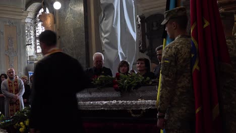 A-Catholic-Priest-Administers-Last-Rites-Over-The-Coffin-Of-A-Dead-Ukrainian-Soldier-During-A-Funeral-Service-In-Lviv,-Ukraine