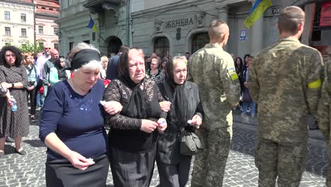 Distraught-Family-Members-Follow-The-Coffin-Of-A-Fallen-Soldier-To-A-Hearse-In-A-Funeral-Procession-On-The-Streets-Of-Lviv,-Ukraine