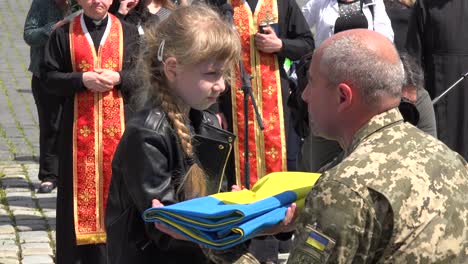 Ein-Kleines-Mädchen-Erhielt-Eine-Ehrenhalber-Gefaltete-Beerdigungsfahne,-Als-Es-Bei-Einer-Militärbeerdigung-In-Lemberg,-Ukraine,-Um-Seinen-Vater-Trauerte