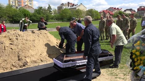 The-Coffin-Of-A-Deceased-Ukrainian-Soldier-Is-Laid-To-Rest-In-An-Open-Grave-At-A-Cemetery-In-Lviv,-Ukraine