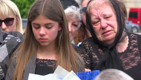 A-Ukrainian-Family-Looks-On-In-Grief-As-Their-Father-Or-Son-Is-Buried-During-The-Funeral-For-A-Fallen-Soldier-In-Lviv,-Ukraine