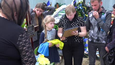 A-Wife-And-Daughter-Say-Goodbye-To-Their-Soldier-Husband-And-Father-At-His-Funeral-During-The-War-In-Ukraine