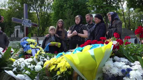 A-Wife-And-Daughter-Say-Goodbye-To-Their-Soldier-Husband-And-Father-At-His-Funeral-During-The-War-In-Ukraine