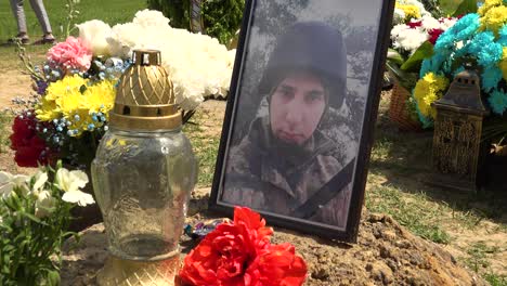 The-Photo-Of-A-Young-Soldier-Atop-A-Grave-Serves-As-A-Poignant-Reminder-Of-The-Tragedy-Of-The-War-In-Ukraine