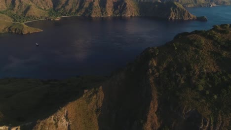Excellent-Aerial-Shot-Of-Mountains-Surrounding-A-Lake-In-Komodo-National-Park,-Indonesia