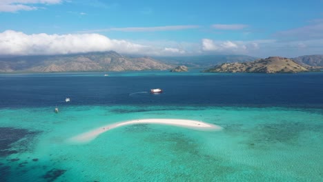 Excellent-Aerial-Shot-Of-Tourists-On-And-Small-Powerboats-Near-Sand-Island-In-Indonesia'S-Komodo-National-Park
