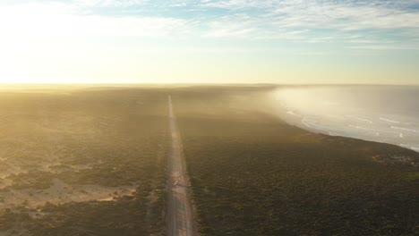 Excellent-Aerial-Shot-Of-A-Car-Driving-On-A-Solitary-Road-By-Streaky-Bay-On-Eyre-Peninsula,-South-Australia