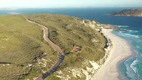 Excellent-Aerial-Shot-Of-Cars-On-Great-Ocean-Drive-Headed-For-The-Beach-In-Esperance,-Australia