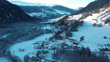 Excellent-Aerial-View-Of-A-Train-Traveling-Through-The-Snow-In-Alvaneu,-Switzerland