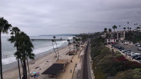 Excellent-Aerial-View-Of-A-Cloudy-Beach-In-San-Clemente,-California,-And-Nearby-Railroad-Tracks