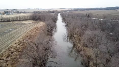 Winter-Time-Aerial-Drone-Video-Of-The-Skunk-River-And-The-Rich-Agricultural-Farmland-Surrounding-Rural-Lynnville,-Iowa