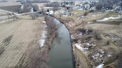 Winter-Time-Aerial-Drone-Video-Of-The-Skunk-River-And-The-Rich-Agricultural-Farmland-Surrounding-Rural-Lynnville,-Iowa