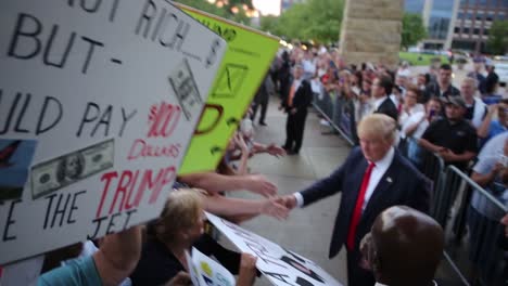 Us-Republican-Presidential-Candidate-Donald-Trump-Shakes-Hands-And-Signs-Autographs-Forsupporters-After-An-Iowa-Caucus-Policital-Campaign-Event