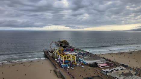 Aerial-Over-The-Historic-Santa-Monica-Pier-And-Amusement-Park-On-A-Cloudy-Day-In-Los-Angeles