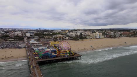 Aerial-Over-The-Historic-Santa-Monica-Pier-And-Amusement-Park-On-A-Cloudy-Day-In-Los-Angeles