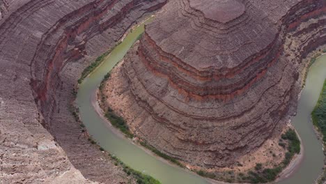 Excellent-Aerial-Shot-Of-The-San-Juan-River-Curving-Around-A-Large-Rock-Formation-In-Utah