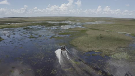 Excellent-Aerial-Shot-Of-An-Airboat-Traveling-Across-The-Florida-Everglades