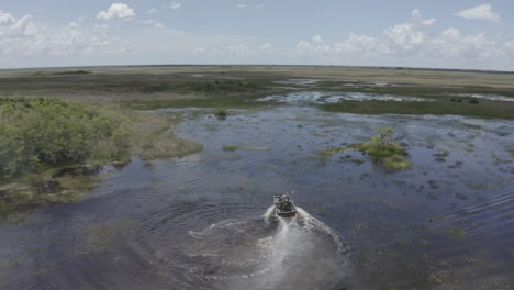 Excellent-Aerial-Shot-Of-An-Airboat-Traveling-Across-The-Florida-Everglades