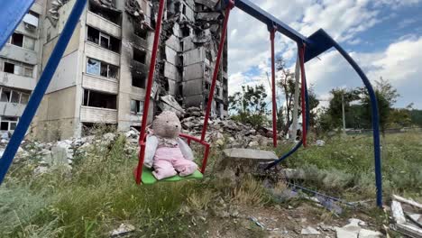 A-Playground-With-A-Teddy-Bear-On-Swing-And-Buildings-Are-Destroyed-By-Russian-Airstrikes-In-The-Saltivka-Region-Of-Kharkiv-Ukraine