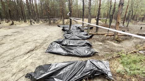 Body-Bags-And-Mass-Graves-Suggest-Russian-War-Crimes-In-A-Forest-In-Izium,-Ukraine-Following-The-Regions-Liberation