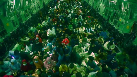 Hundreds-Of-Afghan-Refugees-Sit-In-The-Cargo-Hold-Of-An-American-C-17-Globemaster-During-The-American-Evacuation-Of-Afghanistan