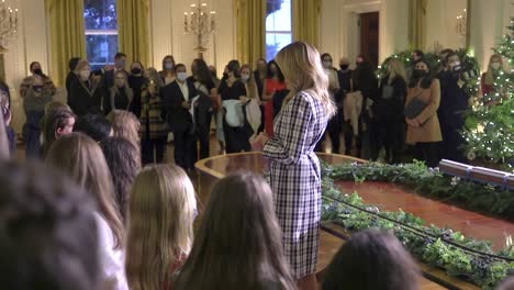 Melania-Trump-Leads-A-Group-Of-Children-Wearing-Masks-During-Covid-19-Thru-The-White-House-Christmas-Decorations