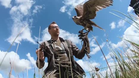 Falconer-Uses-Bird-Of-Prey-To-Keep-Wild-Birds-Away-From-Nato’S-Baltic-Air-Policing-Planes-Sialuiai-Air-Base,-Lithuania