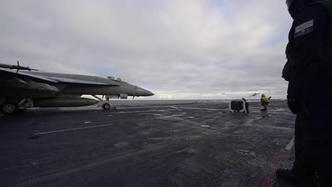 Us-Navy-Sailors-Conduct-Jet-Fighter-Plane-Operations-On-The-Aircraft-Carrier-Uss-Theodore-Roosevelt-Flight-Deck