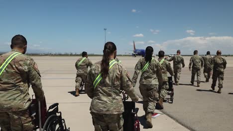Los-Soldados-Saludan-Al-Avión-Comercial-De-Pasajeros-De-Southwest-Airlines-Lleno-De-Refugiados-Y-Evacuados-Afganos-En-Fort-Bliss,-Texas,-Una-Parada-En-El-Camino-Del-Reasentamiento.