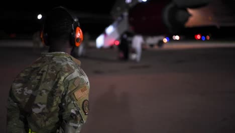 Nightime-Footage-Of-Holloman-Afb-Personnel-And-Arriving-Afgan-Refugees-Entering-A-Building-After-Fleeing-Afganistan