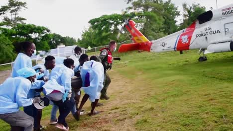 Us-Coast-Guard-Jayhawk-Helicopter-Medivac-Crew-Medivac-Assists-Haitian-Doctors-Providing-Aid-To-Earthquake-Victims
