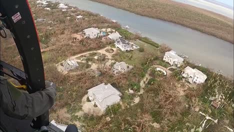 Us-Coast-Guard-Aircrew-Helicopter-Over-Storm-Damaged-Island-Neighborhoods-Hurricane-Ian-Near-Fort-Myers-Beach,-Fl