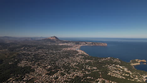 Aerial-View-Of-Javea-Coastline-In-Alicante-With-Dolly-Forward,-Tilt-Down-Over-Housing-Development