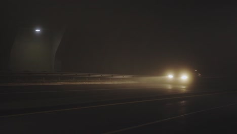 Cars-Drive-On-Speed-Under-A-Dark-Bridge-On-Foggy-Evening