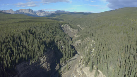 Aerial-descent-into-rugged-canyon,-Nordegg,-Alberta,-Canada