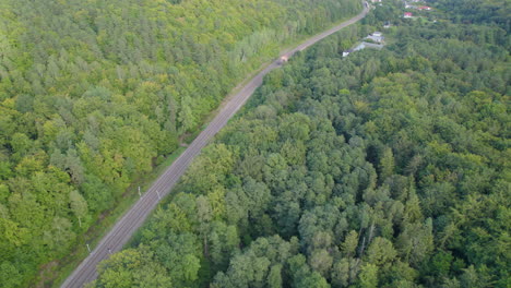 Fly-Away-At-Evergreen-Forest-With-Paved-Road-In-Gdynia-Witomino,-Poland