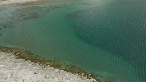 Aerial-view-of-the-beautiful-clear-water-of-Lake-Strobel-in-Argentina